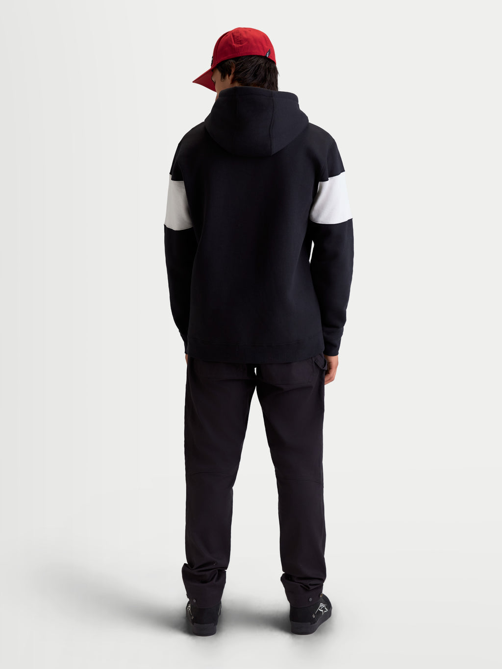 Alpinestars Cubic Hoodie, Unisex Sportswear Pullover Fleece, Black and White Color-Blocked Sleeves, Back View on Model, Premium Cotton Blend Construction, Casual Off-Bike Apparel.