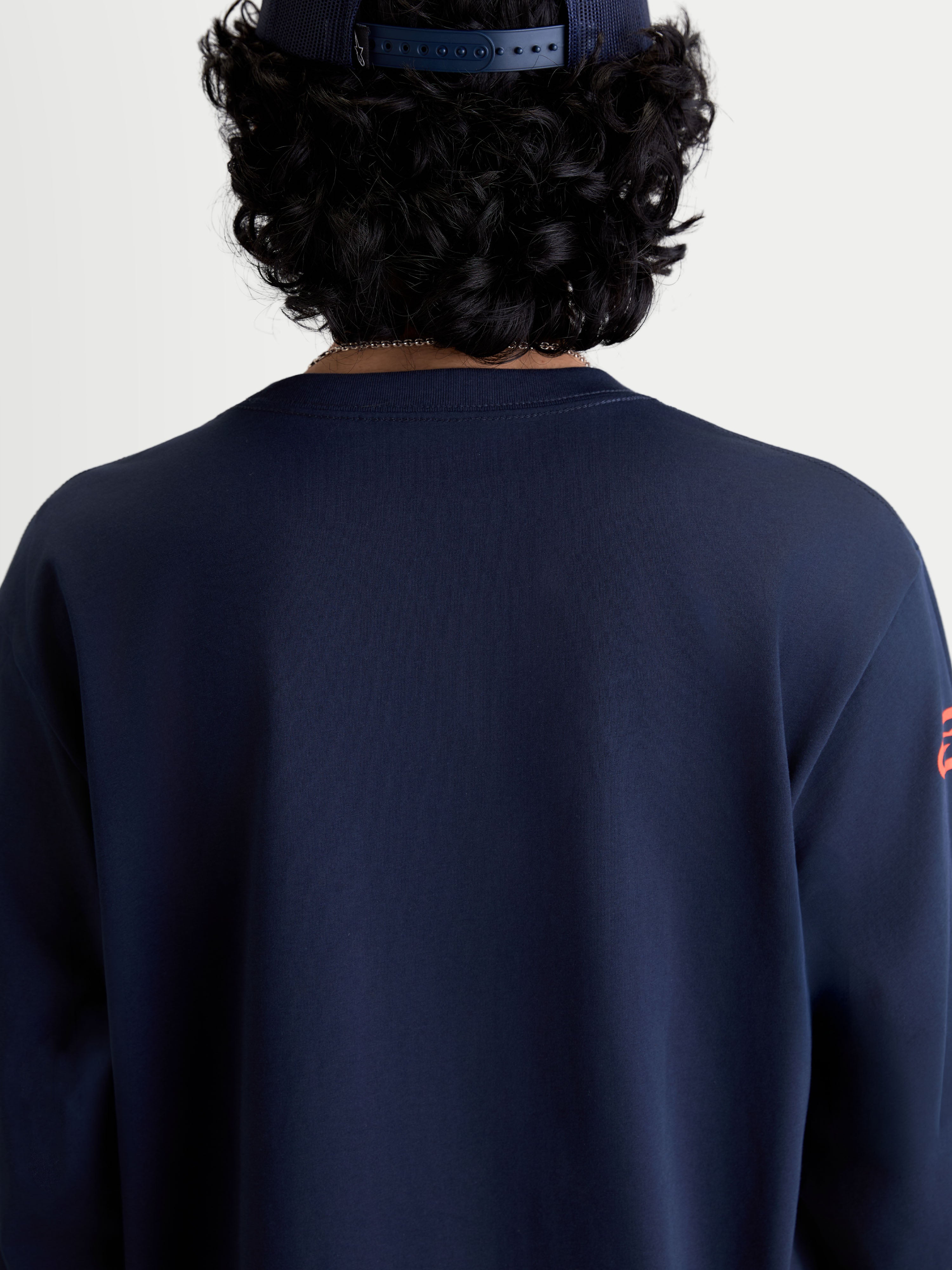 Alpinestars Velocifier CSF Tee, Long Sleeve Sportswear T-Shirt in Navy Blue, back view on model featuring a ribbed crew neck, motorsport-inspired casual apparel made from a soft cotton and recycled polyester blend.