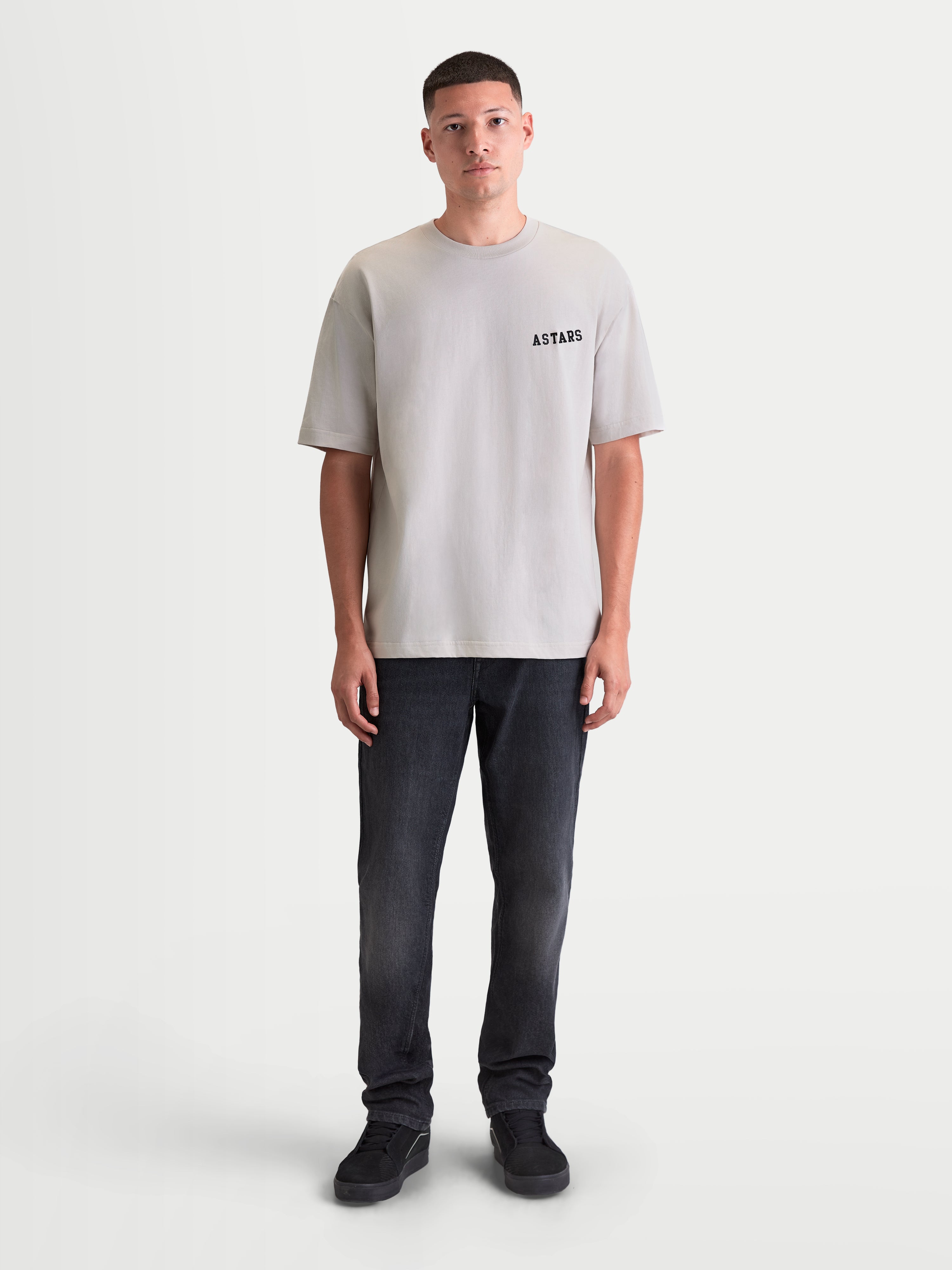 Alpinestars Latitude Oversized CSF Tee, Men's Short Sleeve Sportswear T-Shirt in Cement Gray, featuring a relaxed oversized fit and ASTARS wordmark graphic on the chest, 60/40 cotton-poly blend, front full-body view on model.
