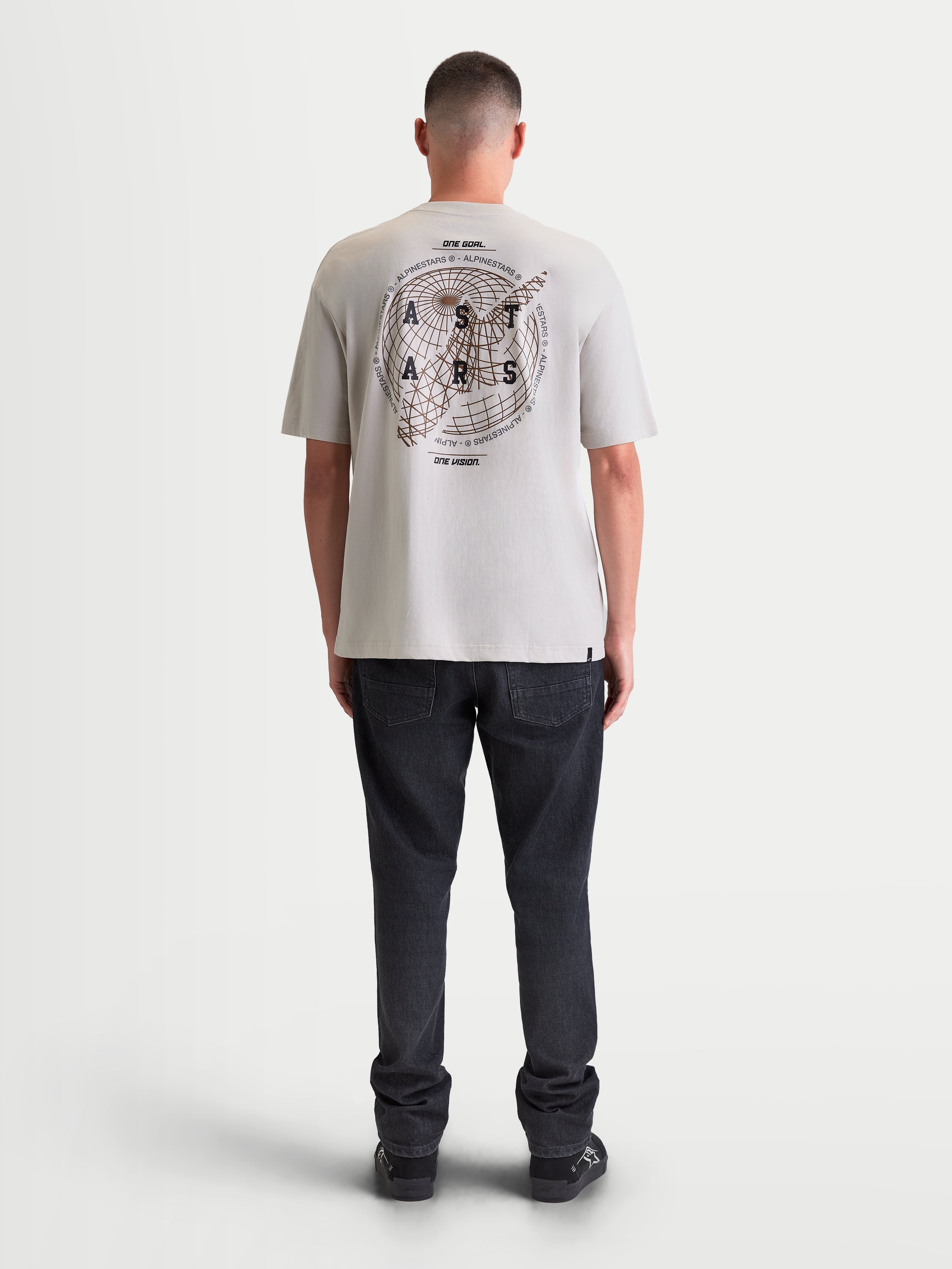 Alpinestars Latitude Oversized CSF Tee, Men's Short Sleeve Sportswear T-shirt in Cement Gray, rear view on model showing large globe and wordmark graphics on the back, relaxed oversized fit.