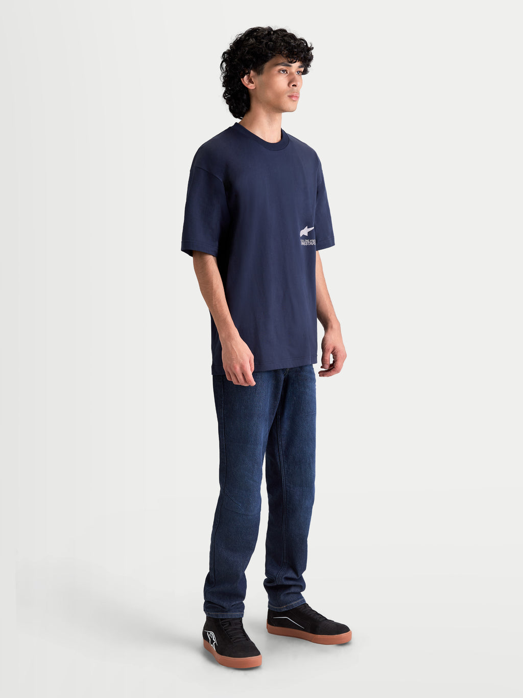 Alpinestars Institute Oversized CSF Tee, Men's Sportswear T-Shirt, Navy Blue, on-model side view showing the relaxed fit and white logo graphic on the side chest, premium cotton-poly blend material.
