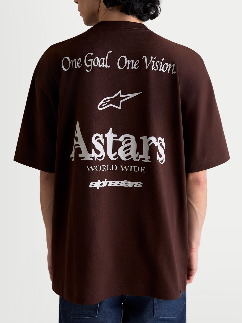 Alpinestars Post Oversized CSF Tee, Short Sleeve Sportswear T-Shirt, Unisex, Brown and White, rear view featuring large white back graphics with 'One Goal. One Vision.' slogan, Astars logo, and 'Astars World Wide' text, relaxed oversized fit, comfortable cotton-poly blend.