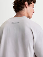 Alpinestars Prelude Oversized CSF Tee, Short Sleeve Sportswear T-Shirt, Cement Gray and Black, back view on model showing Alpinestars wordmark graphic, relaxed oversized fit cotton-poly blend.