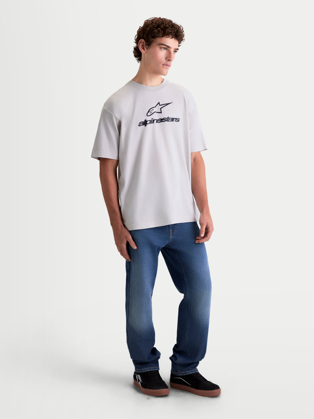 Alpinestars Prelude Oversized CSF Tee, short sleeve casual sportswear t-shirt on model, Cement gray with black Astars stacked logo on the chest, relaxed oversized fit cotton-poly blend for everyday comfort.
