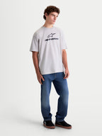 Alpinestars Prelude Oversized CSF Tee, short sleeve casual sportswear t-shirt on model, Cement gray with black Astars stacked logo on the chest, relaxed oversized fit cotton-poly blend for everyday comfort.