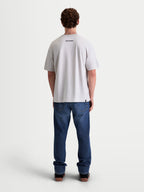 Alpinestars Prelude Oversized CSF Tee, Men's Short Sleeve Sportswear T-Shirt, Cement Gray, back view on model featuring a small black Alpinestars word logo and a relaxed oversized fit, premium cotton-poly blend construction for off-bike style.