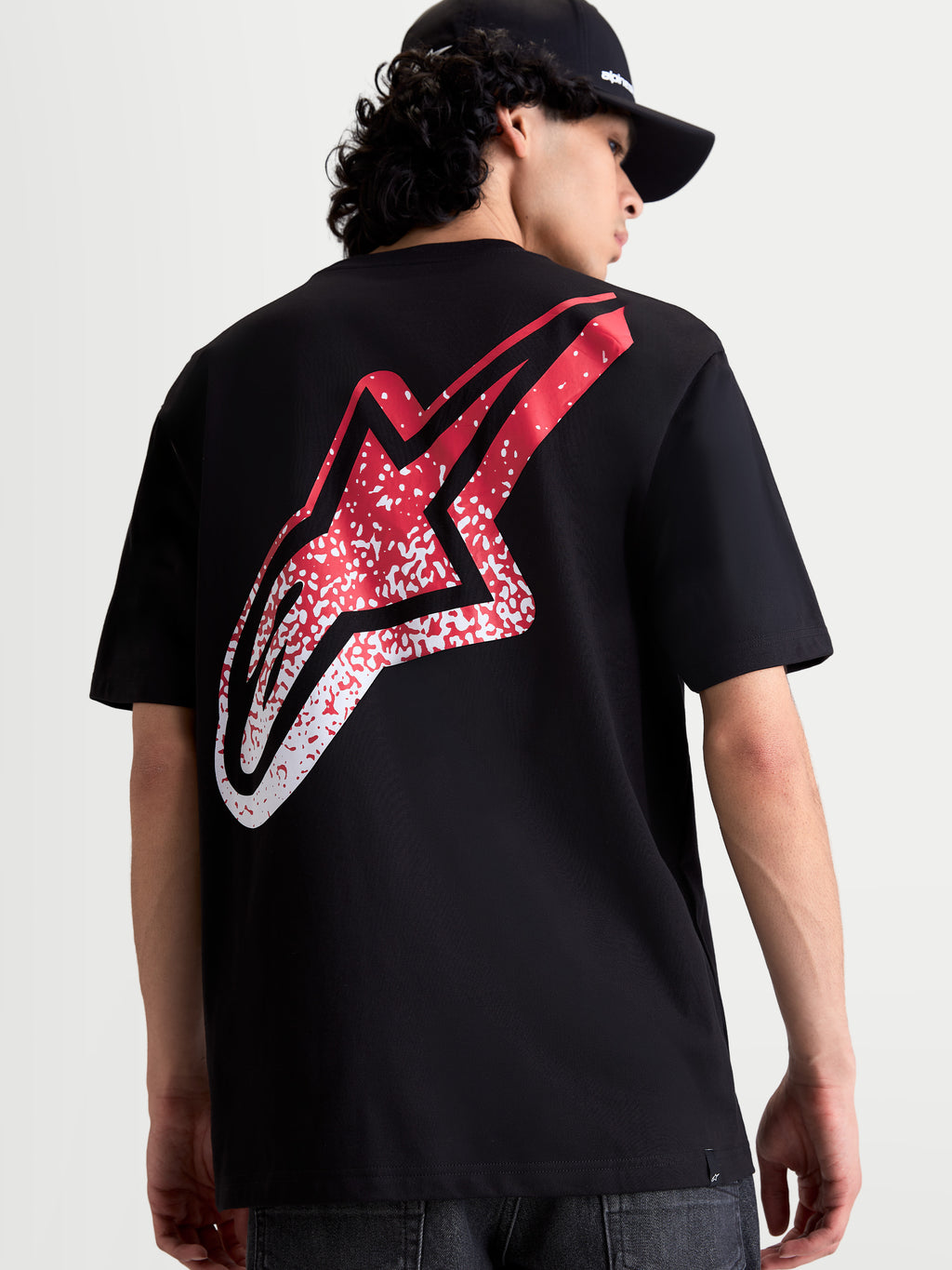 Alpinestars Meteor CSF Tee, Short Sleeve Sportswear T-Shirt, Black with large red and white MX-inspired gradient Astars logo on the back, premium cotton-poly blend, on-model view.