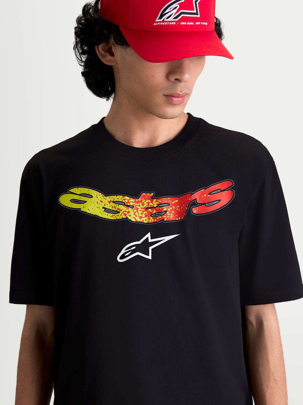 Alpinestars Elliptogrit CSF Tee, Short Sleeve Sportswear, Unisex, Black, featuring a yellow and red gradient Astars wordmark and white logo chest graphic, on-model front view.