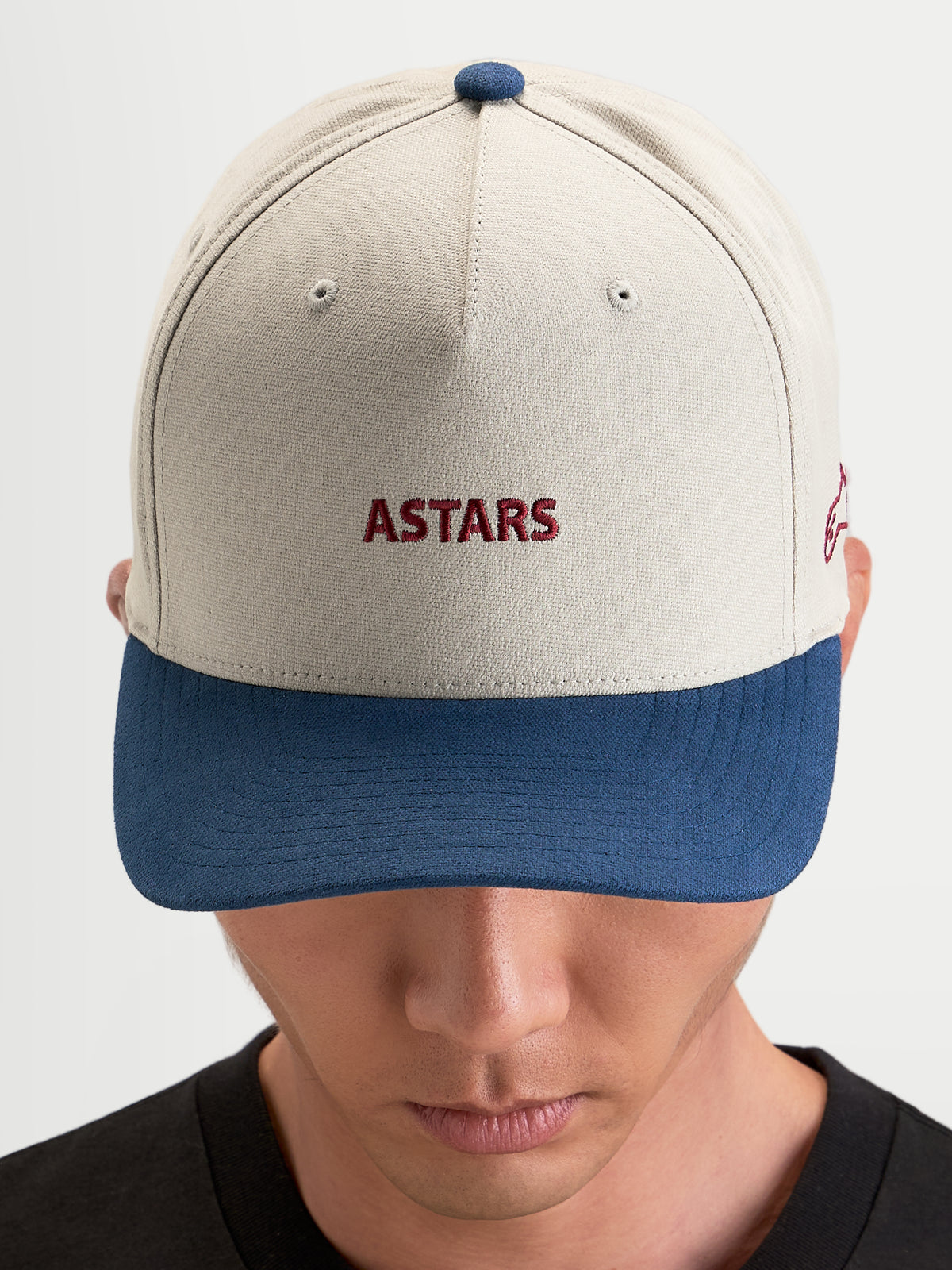 Alpinestars County Canvas Hat, sportswear cap in sand and blue, curved bill, structured crown, featuring front Astars embroidery worn by a model