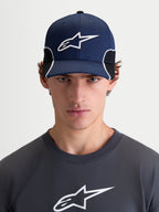 Alpinestars 500 Snapback Hat, Sportswear Baseball Cap for Men, Navy Blue and Black, featuring a curved bill and structured crown with a 3D embroidered Astars logo and white contrast piping, front view on model.