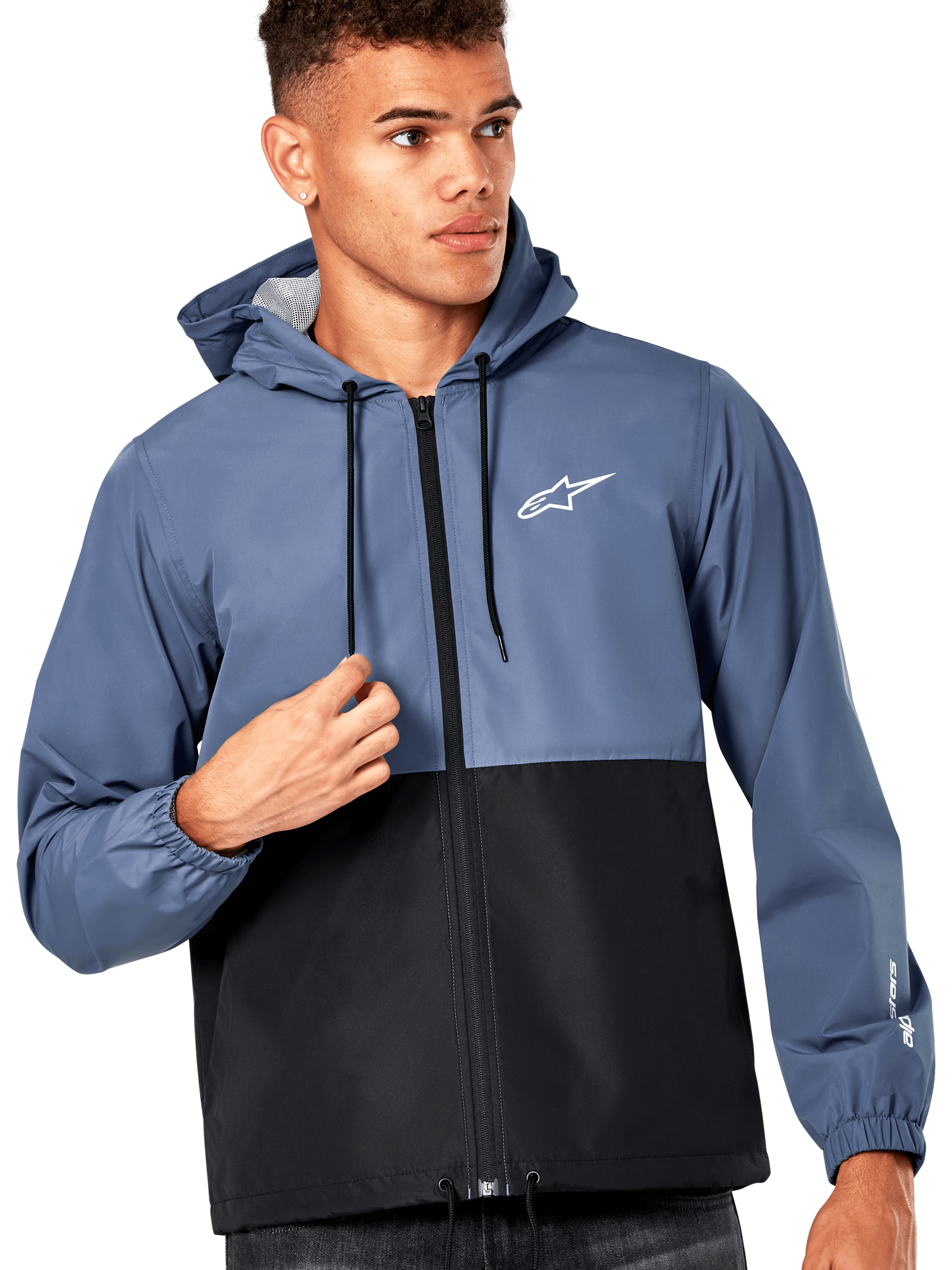Male model wearing Alpinestars Speeder Windbreaker Jacket, Slate Blue and Black color-blocked design, hooded with black drawcords, white logo on chest, casual motorsport-inspired windbreaker
