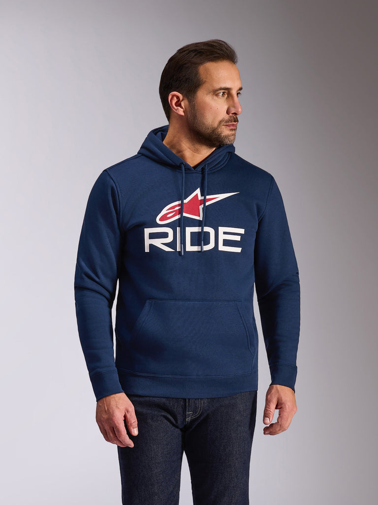 Alpinestars Ride V3 Hoodie, casual navy blue pullover fleece, featuring a white RIDE logo and red Alpinestars star symbol, jersey-lined hood with drawcords, front pouch pocket, modern motorsport-inspired streetwear