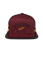 Alpinestars Backline Trucker Hat, flat bill snapback, brick red twill front with black mesh back, mustard yellow logo and side stripes, structured crown with suttache trim on the bill, casual motorsport streetwear