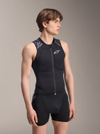 Alpinestars A-Motion Plasma Protection Vest, MTB Protection Vest, Black Camo, sleeveless mesh design with central zipper and chest padding, grey camouflage accents on shoulders, worn by a male model in a studio setting.