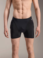 Alpinestars A-Motion Plasma Protection Boxers, MTB Protection Shorts, Black with Black Camo accents, front view on male model, featuring breathable stretch mesh and integrated hip protection for cycling performance.