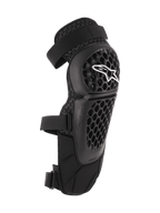 Alpinestars Bionic Plus Knee/Shin Protectors, Black, Off-road and MTB Protection, featuring a perforated honeycomb shell with a white Alpinestars logo, dual adjustable straps, and 3D mesh ventilation, ergonomic curved design
