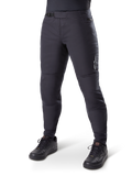 Alpinestars A-Dura Thermal Pant, Black Mountain Bike Pants, worn with black cycling shoes, featuring a ratchet waist closure, small white logo on the thigh, tapered fit for cold-weather riding