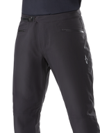Alpinestars A-Dura Waterproof Pants, Mountain Bike Pants, Black, close-up of waist showing ratchet closure system and zippered pockets, featuring a white Alpinestars logo on the thigh, durable textile for wet-weather trail riding