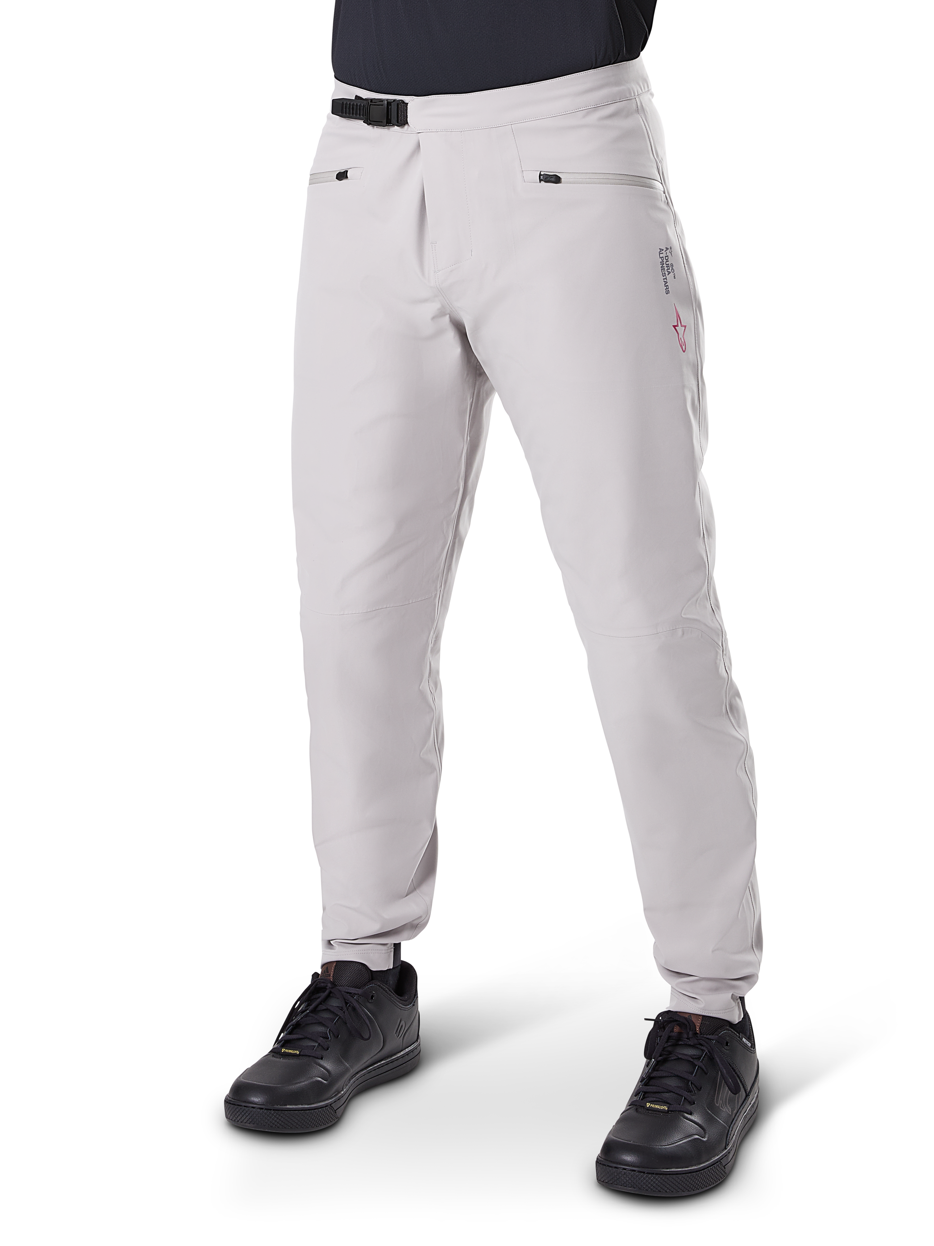 Alpinestars A-Dura Waterproof Pants, Mountain Bike Pants, Titanium Gray, featuring a black ratchet waist closure and zippered hand pockets, tapered legs with elastic cuffs, worn with black shoes, durable 3L waterproof construction for off-road cycling