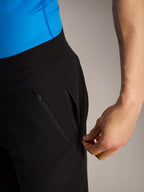 Black Alpinestars A-Dura Ride MTB shorts, close-up of a hand opening one of the three secure zippered side pockets.