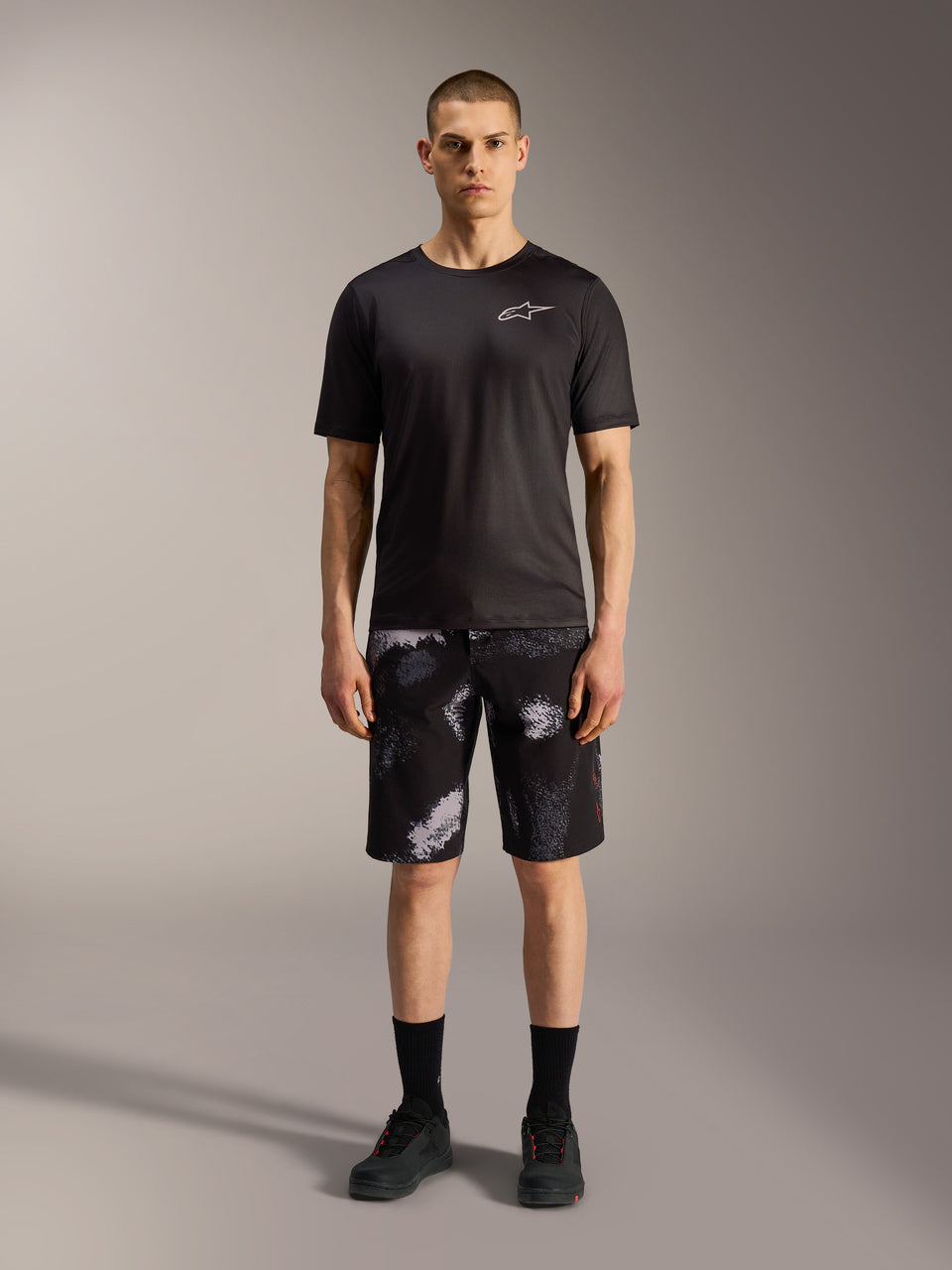 Alpinestars A-Dura Ride Shorts in Black Camo, styled with a black performance tee for mountain bike versatility.