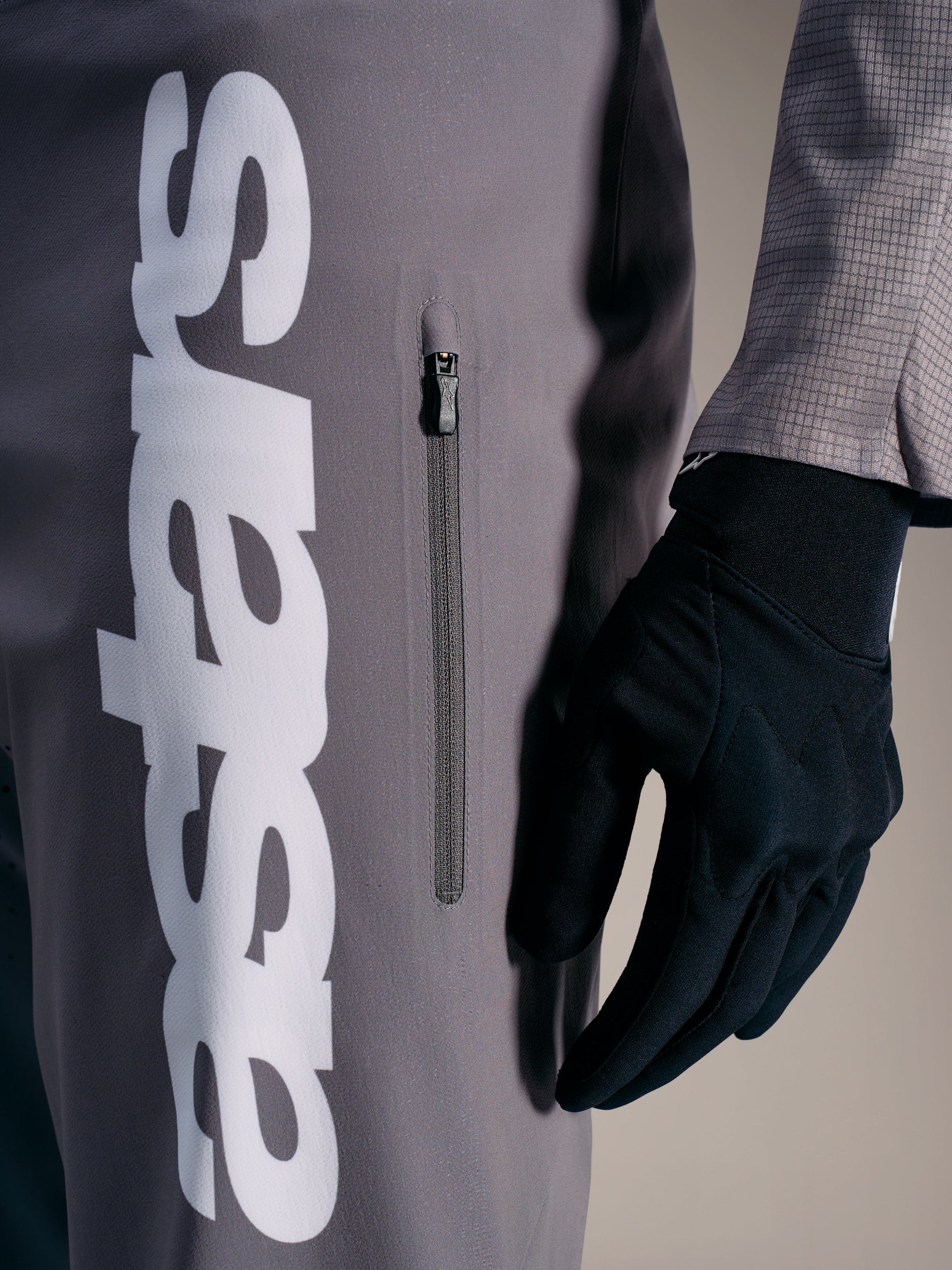 A-Supra Elite Pants in Faded Gray with a bold white logo and vertical zippered pocket, engineered for MTB racing performance.