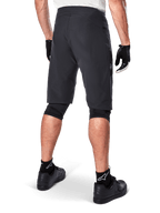Alpinestars A-Aria Shorts, Mountain Bike Shorts, Black, rear view showing performance fit and clean design, worn with black gloves and socks featuring the white Astars logo, technical cycling apparel for off-road riding