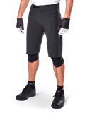 Alpinestars A-Aria Shorts, Mountain Biking Shorts, Black, knee-length with front zippered pockets and adjustable ratchet waist buckle, worn with black knee pads, socks, and cycling gloves