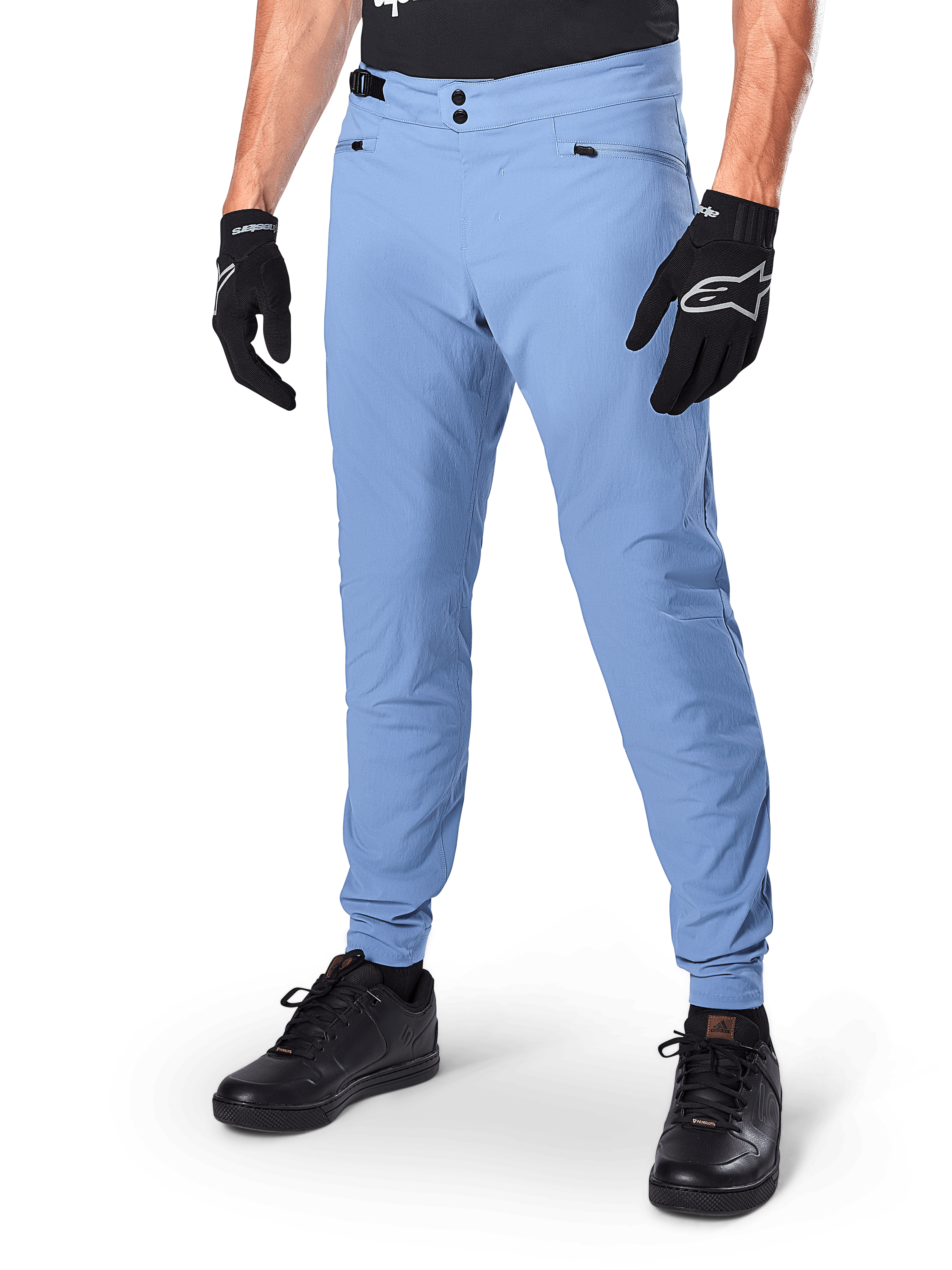 Alpinestars A-Dura Pants, Infinity Blue MTB Cycling Pants, featuring double snap front closure and zippered pockets, worn with black gloves and black shoes, durable 2-way stretch textile for off-road riding