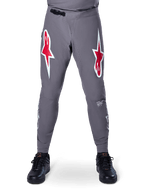 Alpinestars A-Supra Race Pants, MTB Racing Pants, Dark Gray, featuring large red and white star logos on the thighs, laser-perforated ventilation on inner legs, and a black ratchet waist closure, designed for mountain bike racing.