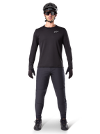 Alpinestars A-Dura Thermal Jersey, Black long-sleeve mountain bike jersey, worn with dark grey pants, black gloves, black helmet and sunglasses, featuring a white Alpinestars logo on the chest, coordinated outfit for cold-weather mountain biking
