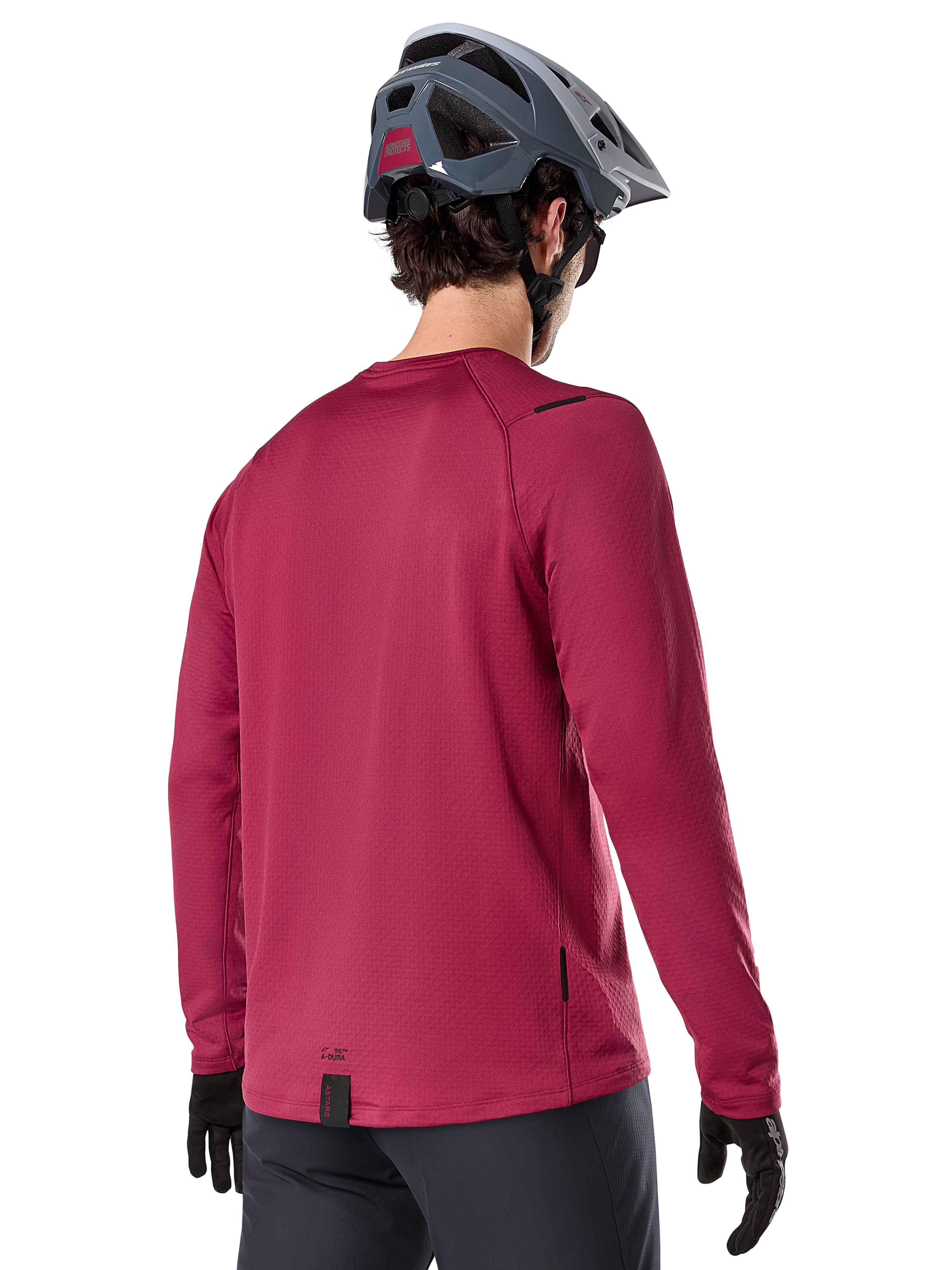 Alpinestars A-Dura Thermal Jersey, Long Sleeve Mountain Bike Jersey, Burgundy, back view on model wearing a grey MTB helmet and black gloves, featuring an extended drop tail and small logo details, designed for cold-weather trail riding.