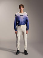 Alpinestars A-Aria Elite Pants, Ecru Performance MTB Pants, off-white cycling trousers with laser-perforated thigh panels and magnetic buckle, worn with gradient blue long-sleeve jersey and black shoes, performance fit for trail riding