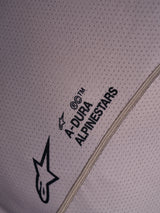 Close-up of gray A-Dura Air Jersey featuring breathable perforated mesh fabric and printed Alpinestars logo branding.