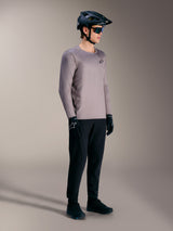 Alpinestars A-Dura Air Long Sleeve Jersey in gray, paired with a black MTB helmet and performance gear for trail riding.
