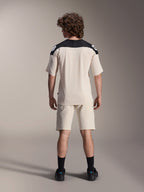 Alpinestars A-Aria Polartec Elite Short Sleeve Jersey, MTB Cycling Jersey, Ecru with black shoulder panels, back view shown with matching shorts and black socks, performance fit with a dropped tail design for off-road riding.