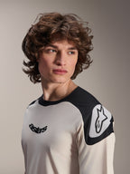 Alpinestars A-Aria Polartec Elite Short Sleeve Jersey, Ecru with black shoulder panels, featuring black astars logo on chest and white Astars logo on shoulder, high-performance mountain bike gear worn by model