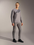 Gray A-Dura Ride Long Sleeve Jersey featuring a black chest logo, styled on a model for a complete mountain biking look.