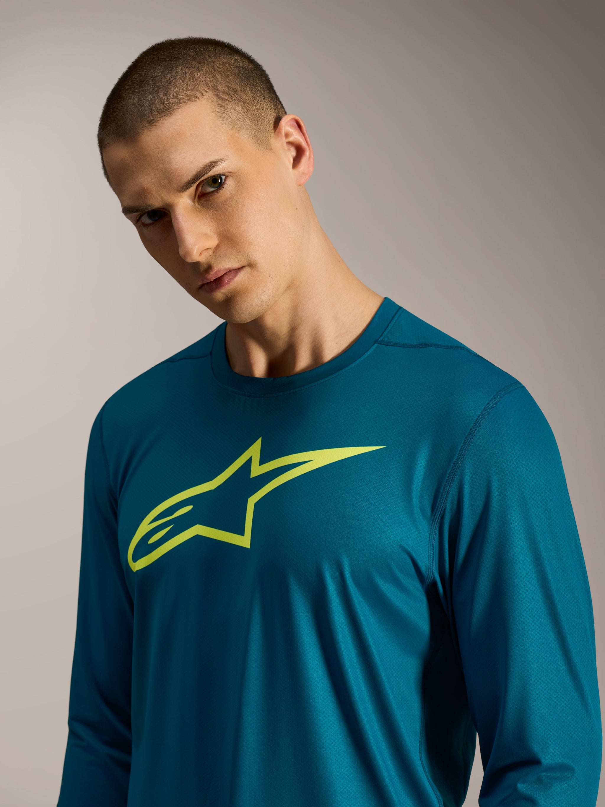 Blue-green A-Dura Ride Long Sleeve Jersey with a lime Alpinestars logo on the chest, performance mountain bike apparel.