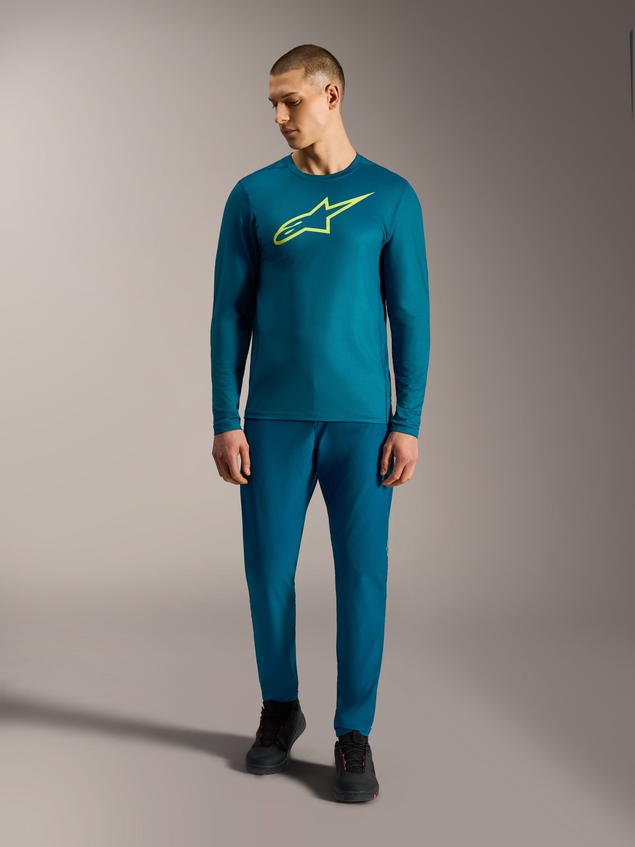Alpinestars A-Dura Ride Long Sleeve Jersey in blue green with a lime yellow logo, performance MTB apparel for men.