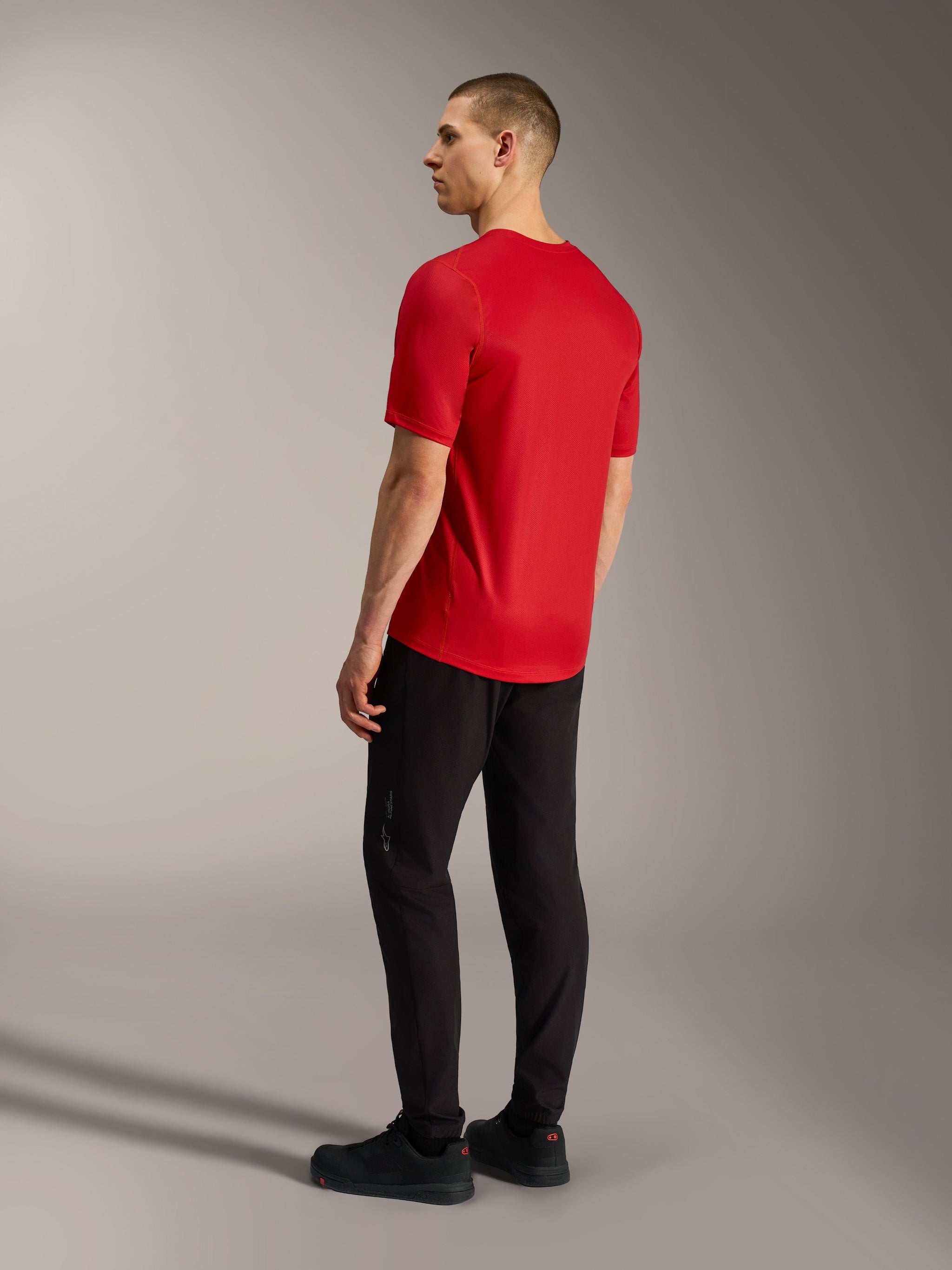 A-Dura Ride Short Sleeve Jersey in red, rear view showing drop tail design and stretch fabric construction for MTB performance.