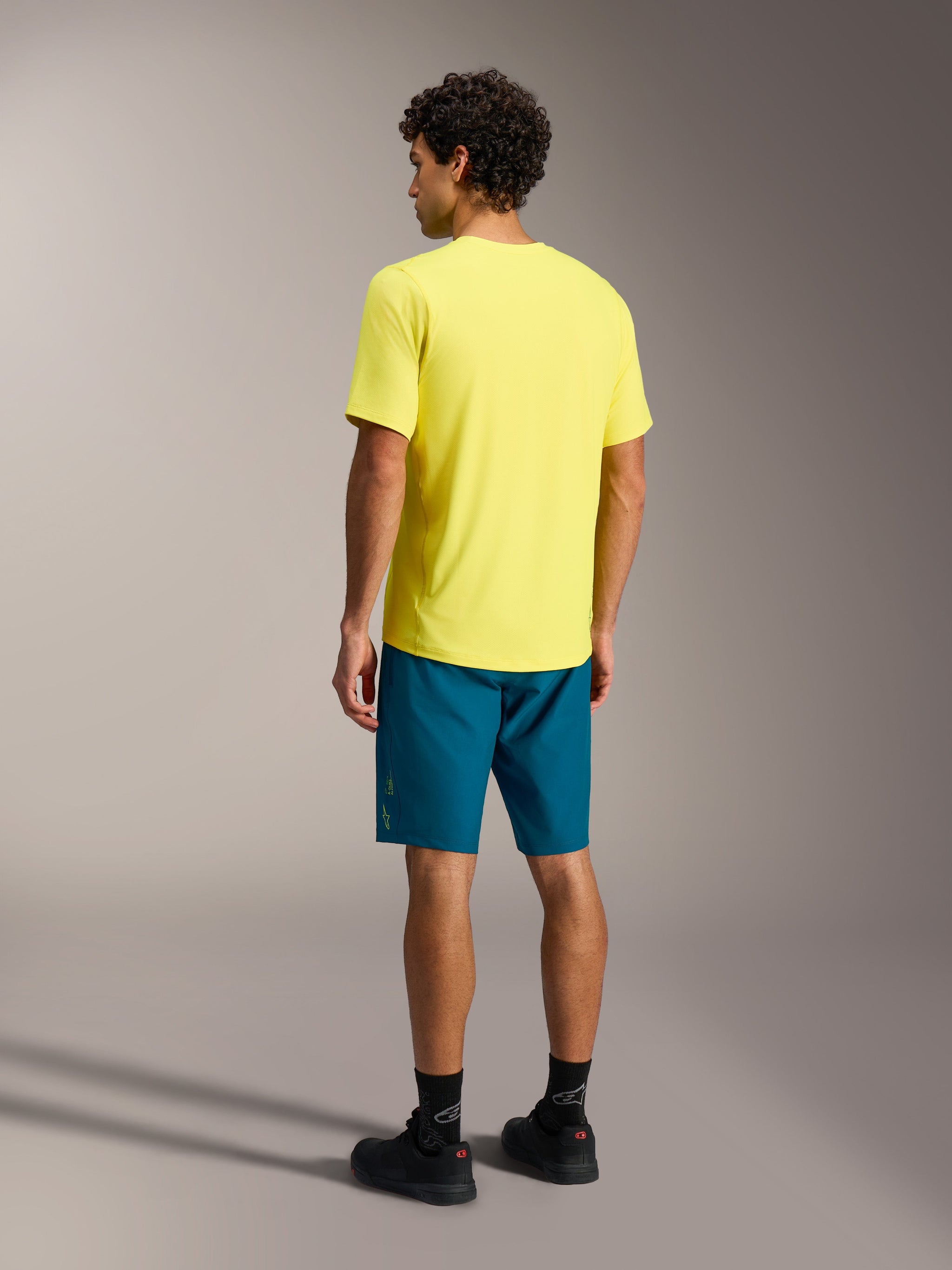 A-Dura Ride Short Sleeve Jersey in Yellow Fluo, rear view showing the dropped tail design for mountain bike performance.