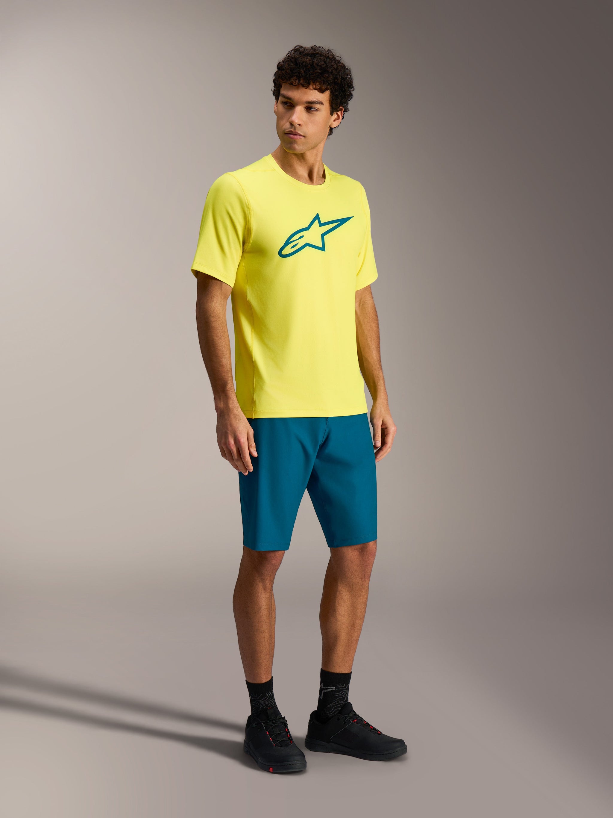 Alpinestars A-Dura Ride Short Sleeve Jersey in Yellow Fluo with a teal logo, designed for performance MTB trail riding.