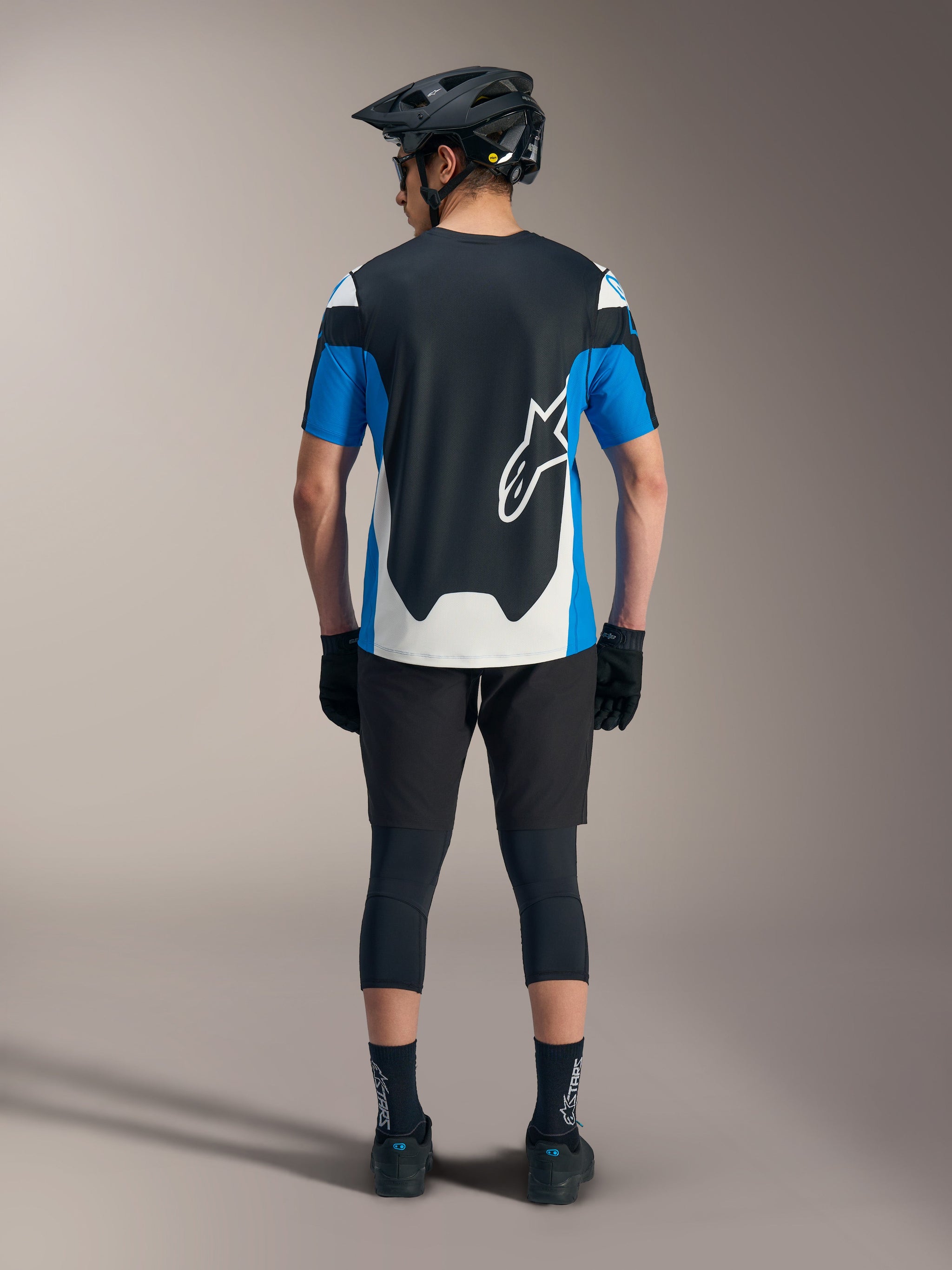 Alpinestars A-Dura Race SS Jersey in blue and black, styled with technical MTB shorts and performance gear.