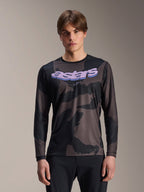 Alpinestars A-Dura Hollow Camo Long Sleeve Jersey, MTB Mountain Bike Jersey, Black and Gray Camouflage Pattern, Purple 'astars' graphic on chest, worn by model with black pants, casual performance design