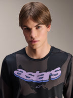 Alpinestars A-Dura Hollow Camo Jersey - Long Sleeve, Black Camo with purple 'astars' chest graphic, studio shot of male model wearing MTB apparel, casual and technical mountain bike style