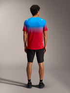 A-Dura ASTARS Jersey 2.0 in red and blue gradient, short sleeve MTB top shown from the back with black shorts.