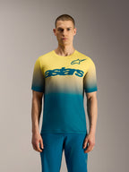 A-Dura ASTARS Jersey 2.0, short sleeve MTB top with blue green to yellow fluo gradient and bold chest logo.