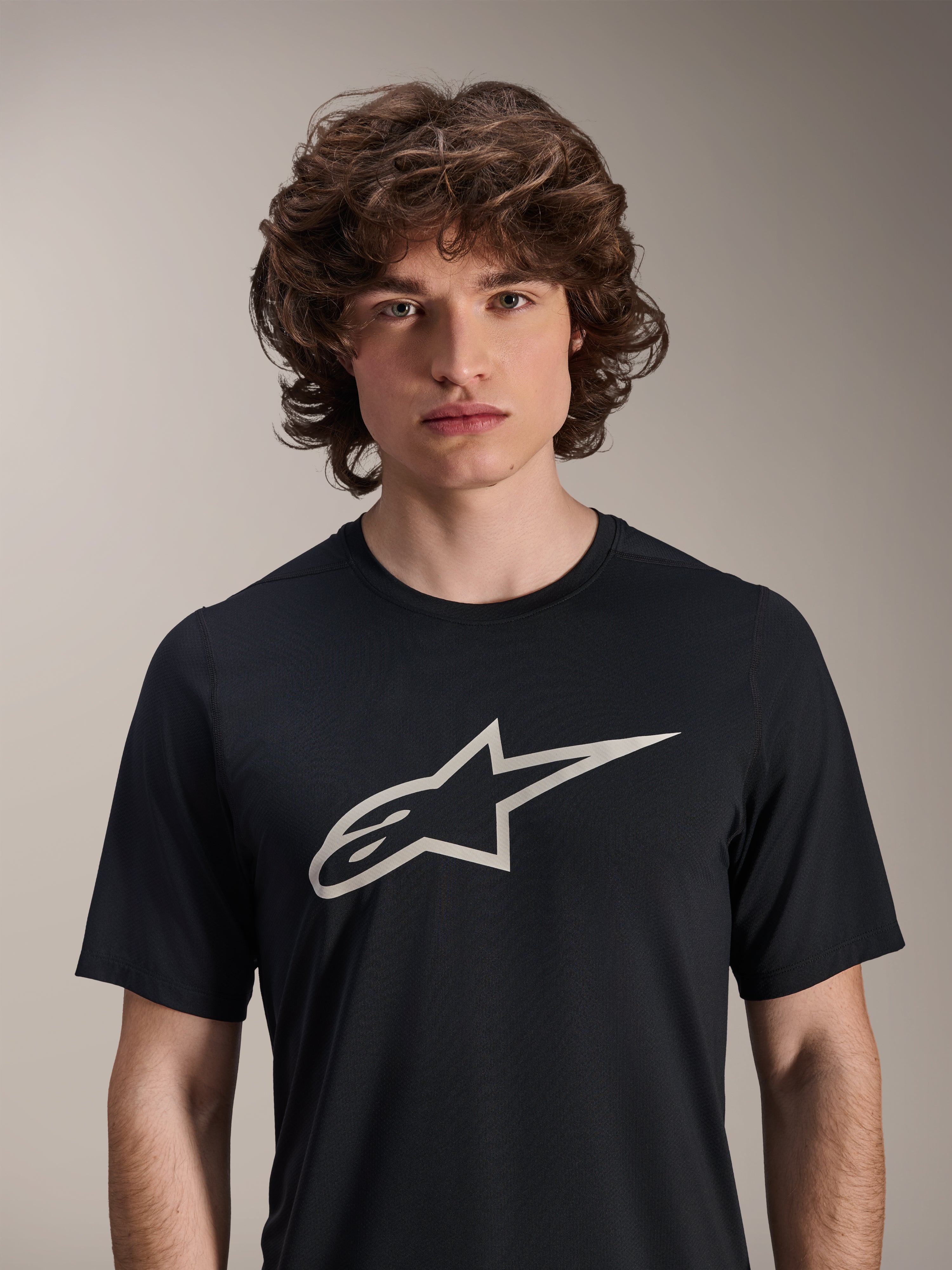 Alpinestars A-Dura Astar Short Sleeve Jersey, Black, featuring a large white Astar logo on the chest, worn by a male model, casual mountain bike performance apparel