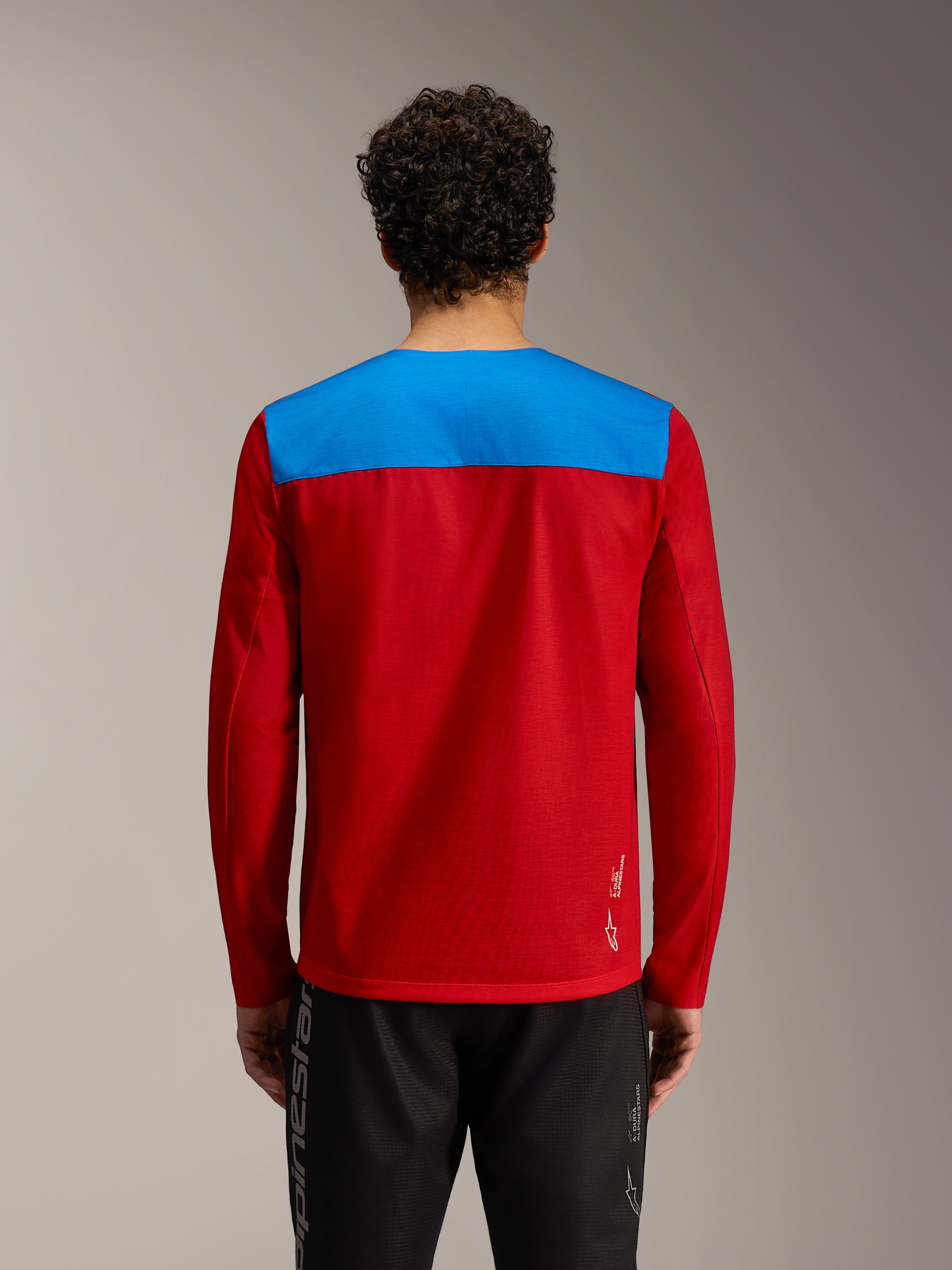 Red and blue A-Dura Elite Jersey 2.0, long sleeve MTB top with white Alpinestars logo, studio back view.